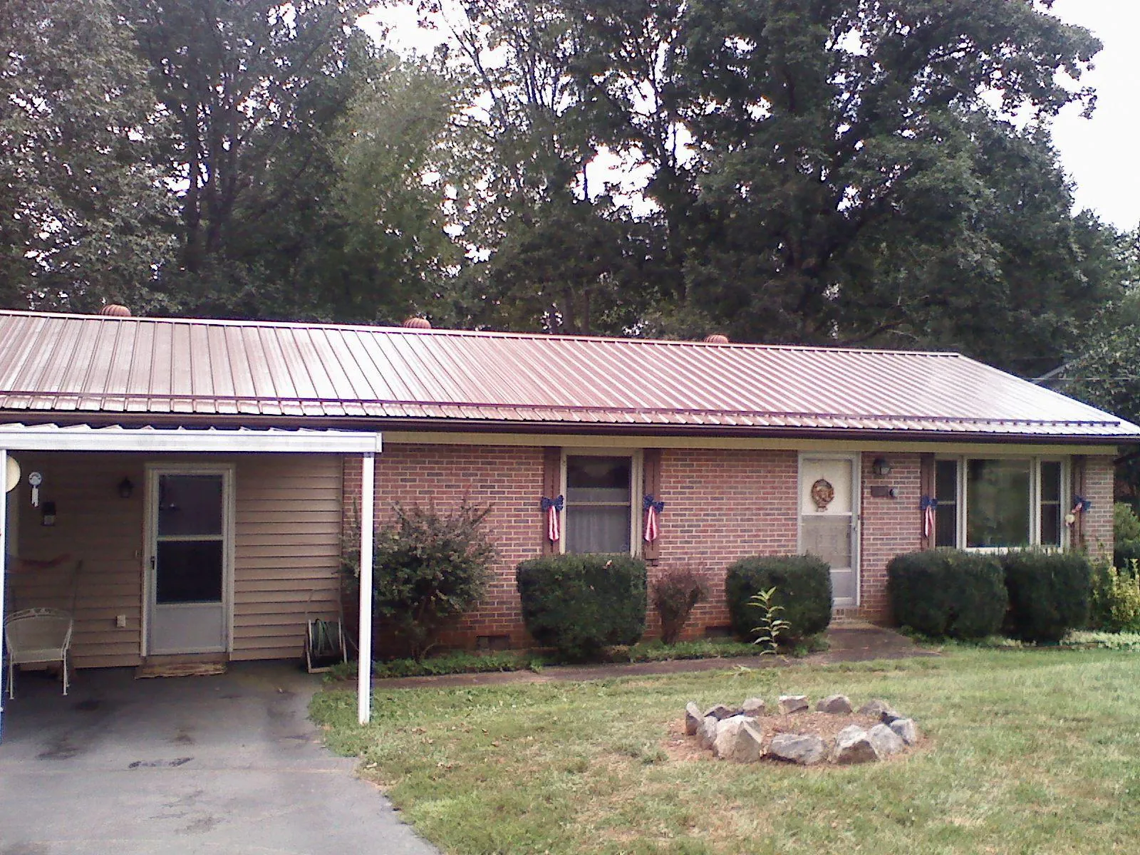 Bronze metal roof and carport on a brick ranch home — Roof Repair work by our crew in Cornwall On Hudson